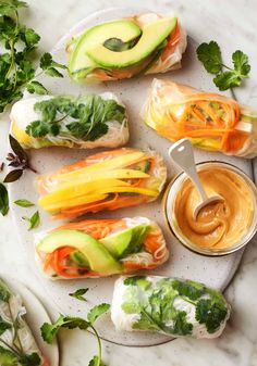 an assortment of veggies and dips on a plate