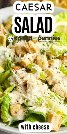 a salad with croutons, lettuce and cheese on it in a white bowl