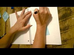 two hands are writing on a notepad while another hand is holding a pen in the other hand