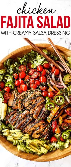 chicken fajita salad with creamy salsa dressing in a wooden bowl on a marble surface