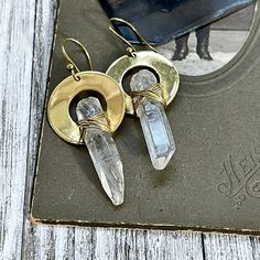 Brass Drop Earrings with Natural Clear Quartz Crystals Each crystal is a natural stone and will vary in shape. Dimensions are approximately 2.38" long This listing is for 1 pair of earring. Pictures are an example of what yours will look like. Each piece is unique and beautiful. Please allow for differences. Part of the Curated by @foxlark collection Handcrafted natural stone, crystal, sterling silver and brass jewelry handpicked by me just for you! • Each piece and crystal is unique and beautif Wire Wrapped Brass Crystal Drop Earrings, Wire Wrapped Brass Drop Crystal Earrings, Stone Crystal, Quartz Crystals, Clear Quartz Crystal, Brass Jewelry, Clear Quartz, Statement Jewelry, Quartz Crystal