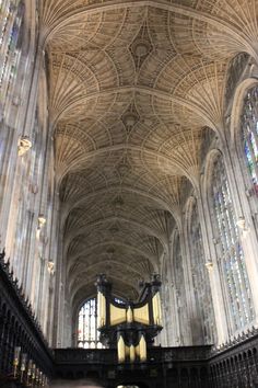 the interior of a cathedral with vaulted ceilings and stained glass windows