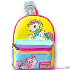 My Little Pony Has A Colorful Artwork Covers All Sides Of This Handy Backpack In Bold Blocks Of Yellow, Pink, Seafoam Green, Purple, And Blue. Fan-Favorite My Little Pony Characters Come To Life In Playful Prints. You Might Spot Starshine, Peachy, Applejack, Glory, Skydancer, Blossom, And Snuzzle. Pack Just What You Need For The Day To Take The Reins In Style. Features: Vegan Leather (Polyurethane) Padded, Adjustable Shoulder Straps Zippered Front Pocket For Securing Smaller Items Side Pockets S Cute Yellow School Backpack, Cute Yellow Travel Backpack, Cute Yellow Backpack For Back To School, Cute Yellow Backpack Bag, Fun Multicolor Standard Backpack, Playful Multicolor Backpack With Adjustable Strap, Yellow Softback Backpack For Back To School, Yellow Backpack With Adjustable Strap For Back To School, Yellow Backpack For Back To School With Zipper