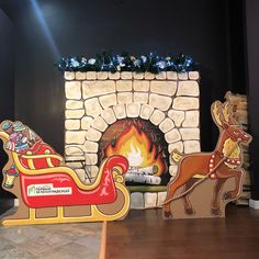 there is a fire place with santa's sleigh and reindeers