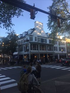 people crossing the street in front of a building