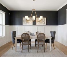 a dining room table with chairs and a chandelier