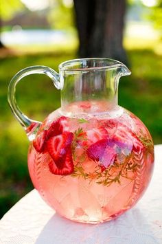 a pitcher filled with liquid sitting on top of a table