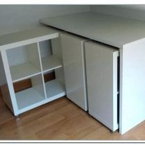 a small white cabinet sitting next to a radiator on a hard wood floor