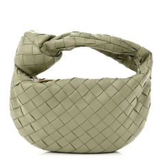 This is an authentic BOTTEGA VENETA Nappa Intrecciato Mini Jodie in Travertine. This stylish handbag is beautifully crafted of soft woven nappa leather in light green. The bag features a matching handle and a gold top zipper that opens to a compact matching leather interior. Designer Bags With Interwoven Design For Shopping, Designer Shoulder Bag With Interwoven Design For Shopping, Designer Top Handle Shoulder Bag With Interwoven Design, Leather Evening Bag With Interwoven Design, Designer Leather Bags With Interwoven Design, Designer Hobo Bag With Intrecciato Weave For Shopping, Luxury Leather Woven Shoulder Bag, Designer Green Bags With Intrecciato Weave, Elegant Woven Leather Hobo Bag