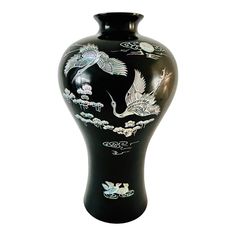 a black vase with white designs on it