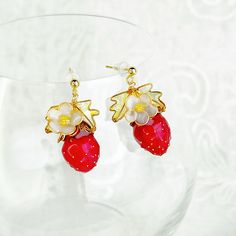 Handmade Strawberry Plant Earrings These Handmade Strawberry Plant Earrings feature a detailed design of a strawberry planet with delicate leaves and a flower, making them a unique and thoughtful gift. Each earring is carefully crafted by hand, ensuring a one-of-a-kind piece. Add a touch of charm to any outfit with these whimsical earrings. As a gift shop, we offer a complimentary gift box for every order. Detail: Size of earring:12mm*30mm  Material: flowers - resin; ear wires - sterling silver Fruit Design Drop Earrings As Gift, Fruit Design Drop Earrings For Gift, Handmade Berry Colored Earrings For Gift, Handmade Berry Earrings For Gift, Handmade Flower Shaped Clip-on Earrings For Gifts, Gold Earrings With Fruit Design For Gift, Berry Colored Fruit Design Earrings For Gift, Berry-colored Fruit Design Earrings For Gift, Whimsical Earrings