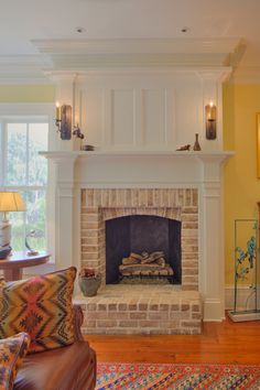 a living room filled with furniture and a fire place in the middle of a room