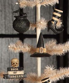 a christmas tree decorated with black and white shoes, skull ornaments, and a book