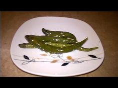 some green peppers are on a white plate