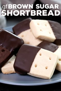 several pieces of chocolate and marshmallow on a blue plate with other dessert items