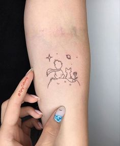 a woman's left arm with a small tattoo on the side of her leg