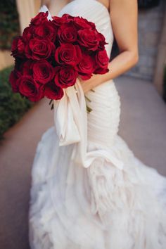 a woman holding a bouquet of red roses in her hand and the caption reads, brides follow