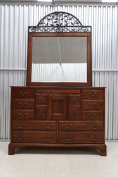 a large wooden dresser with a mirror on top