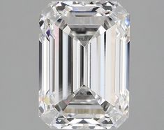 an emerald cut diamond on a gray background with the center stone in white and black