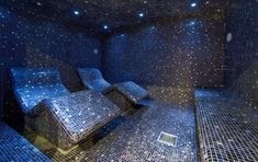 an artistic room with blue tiles and stars on the ceiling