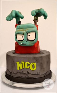 a cake decorated with an image of a cartoon character on it's face and hands