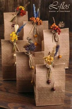 four brown bags with flowers tied to them