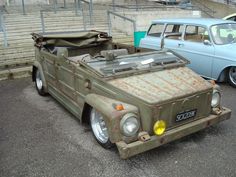 an old car is parked in a parking lot