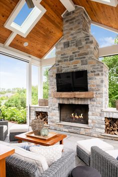 a living room filled with furniture and a flat screen tv mounted on the wall above a fire place