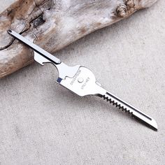 a pair of scissors that are sitting on a piece of wood with some nails in it