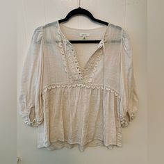 Elevate Your Wardrobe With This Gorgeous Max Studio Antique Peasant Blouse. The Ivory Color And Lace Trim Make It Perfect For Any Occasion, Whether It Be A Casual Day Out Or A Business Meeting. This Generously Sized Blouse In A Size Small Features A Split Neckline With Tie And 3/4 Balloon Sleeves, Adding A Touch Of Elegance To The Overall Tunic Style. Summer Peasant Top With 3/4 Sleeves, Peasant Style 3/4 Sleeve Summer Top, Peasant Style 3/4 Sleeve Top For Summer, Bohemian Blouse With 3/4 Sleeves For Daywear, Cream Long Sleeve Peasant Top For Daywear, Cream Peasant Top For Spring Brunch, Spring Cream Peasant Top For Brunch, Peasant V-neck Blouse For Brunch, Peasant Style V-neck Blouse For Brunch