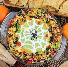 a spider web cake with cheese, black olives and peppers