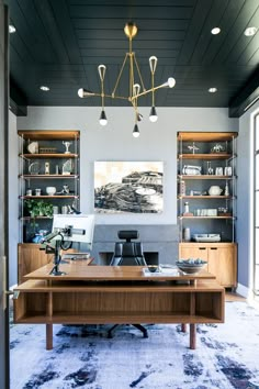 a home office with built - in shelving and desks, along with an area rug on the floor