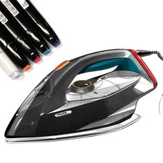 a drawing of an electric iron and four markers on the white paper next to it