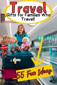 a woman with two children sitting on top of a luggage bag in an airport terminal