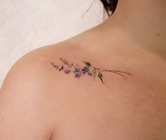 the back of a woman's shoulder with flowers on it