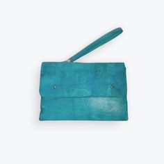 Expertly crafted and handmade, the Nicole Clutch Handbag is a sophisticated choice for any occasion. With its vibrant colors, woven sides, and silver-tone hardware, this clutch adds a touch of elegance to your outfit. The convenient wrist strap allows for easy and stylish carrying. Dimensions: 5.5 in. x 8.25 in. x 1.25 in. Leather Handle Pouch Clutch For Evening, Evening Clutch With Leather Handles, Rectangular Clutch With Leather Handles For Daily Use, Blue Envelope Clutch For Everyday Use, Everyday Rectangular Clutch With Fold Over Clasp, Leather Clutch With Snap Closure And Rectangular Shape, Rectangular Clutch With Snap Closure For Travel, Rectangular Clutch With Fold Over Clasp For Daily Use, Rectangular Travel Clutch With Snap Closure