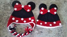 two crocheted hats with red and white polka dots are laying on the floor