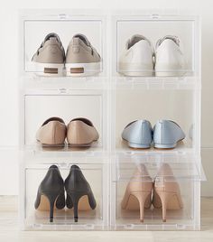 four clear acrylic boxes with shoes in them