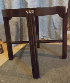 a small wooden stool sitting on top of a carpeted floor