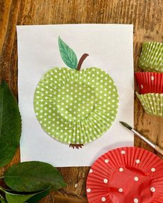 paper plates with green and white polka dots on them next to an apple cutout