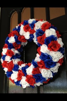 a wreath with red, white and blue flowers