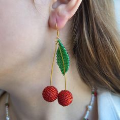 Stand Out with These Playful Cherry Earrings! Who's this for? Looking for a unique accessory to add a touch of personality to your outfit? These cherry earrings are the perfect choice for anyone who loves: Fun and playful jewelry Bright and vibrant colors Unique and eye-catching designs Comfortable and lightweight accessories Characteristics: Handmade with high-quality Czech glass beads Features vibrant red and green cherries Lightweight and comfortable to wear Gold-plated findings for a touch of elegance Versatile and can be paired with any outfit Why it's worth buying: Adds a pop of color and personality to any outfit Makes a perfect gift for a friend or loved one Crafted with attention to detail and high-quality materials Affordable and stylish Ready to add a touch of whimsy to your war Handmade Cherry Jewelry For Party, Handmade Cherry Colored Round Bead Jewelry, Fun Dangling Beads Jewelry As Gift, Fun Dangling Beads Jewelry For Gifts, Fun Jewelry With Dangling Beads For Gift, Cherry Dangle Earrings For Party, Cherry Color Dangle Earrings For Party, Trendy Red Beaded Earrings As Gift, Trendy Red Beaded Earrings