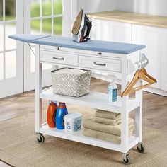 a kitchen cart with towels and other items on it