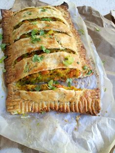 there is a large meat and vegetable pie on the wrapper with it's crust cut in half