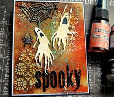 an altered halloween card with spider webs and spooky ink