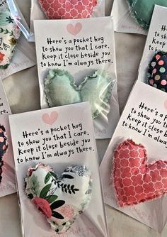 several pieces of heart shaped paper with words written on them and attached to small tags