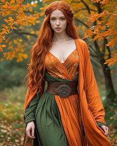 a woman with long red hair wearing an orange and green dress standing in the woods