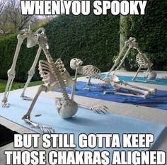 the skeleton is doing yoga outside in front of a pool with other skeletons on it