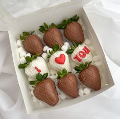 chocolate covered strawberries in a white box with i love you written on the top