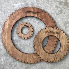 two wooden gears are shown on the floor